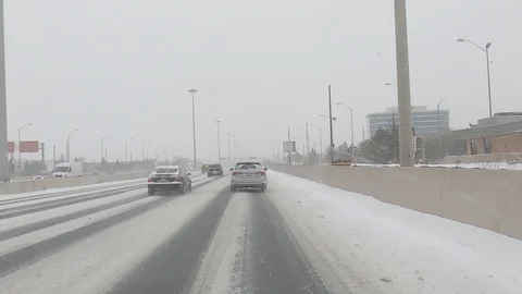 Driving plate POV highway driving in snow storm during cold polar vortex winter Stock Footage 101571908
