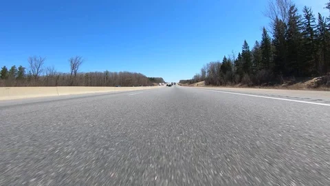 Driving plate of POV low angle on highway with car and truck traffic in Canada. Stock Footage 106394099