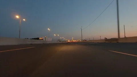 Driving plate POV low angle highway traffic at dusk in the evening Stock Footage 113521258