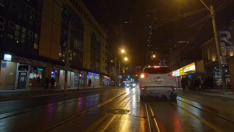 Driving plate POV low angle Toronto dark city streets at night downtown urban Stock Footage 122032511