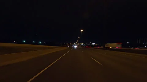 Driving plate POV rear view highway at night with car traffic in the dark Stock Footage 166854593
