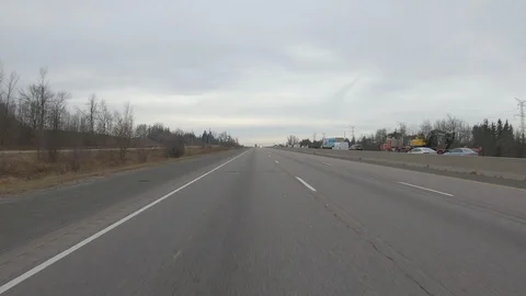 Driving plate POV reverse angle on highway with trucks cars and tractor trailers Stock Footage 100117080