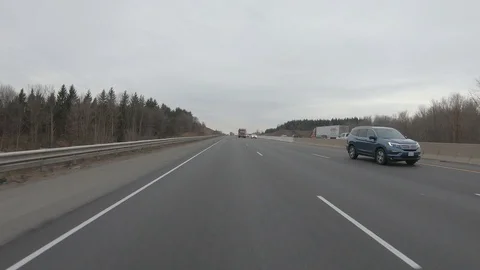 Driving plate POV reverse angle on highway with trucks cars and tractor trailers Stock Footage 100117511