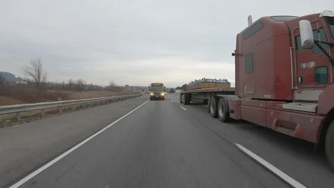 Driving plate POV reverse angle on highway with trucks cars and tractor trailers Stock Footage 100117664