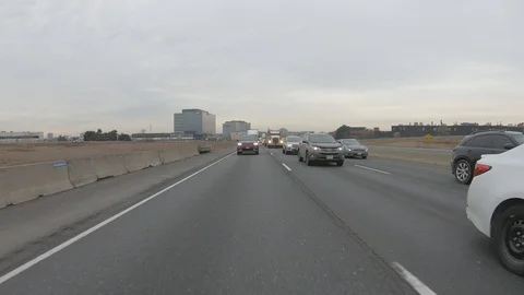 Driving plate POV reverse angle on highway with trucks cars and tractor trailers Stock Footage 100119296