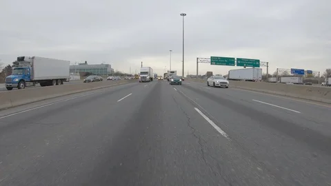 Driving plate POV reverse angle on highway with trucks cars and tractor trailers Stock Footage 100121016