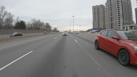 Driving plate POV reverse angle on highway with trucks cars and tractor trailers Stock Footage 100121629