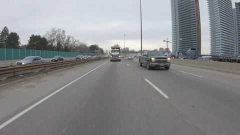 Driving plate POV reverse angle on highway with trucks cars and tractor trailers Stock Footage 100121848