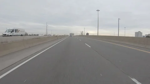 Driving plate POV reverse angle on highway with trucks cars and tractor trailers Stock Footage 100122001