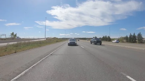 Driving plate POV reverse on open highway with car and truck traffic Stock Footage 117296861