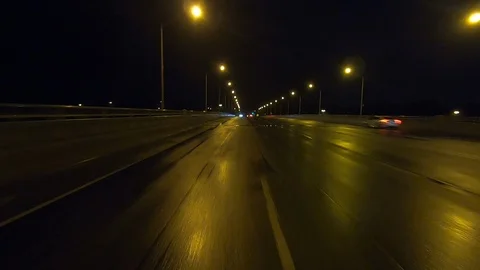 Driving plate POV reverse of traffic on dark rainy night Stock Footage 112925158