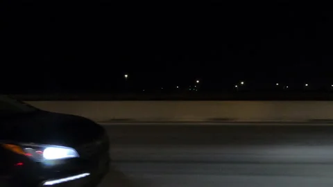 Driving plate POV side view city streets on a very dark night Stock Footage 168176549