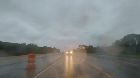 Driving Plate Rear View - on four lane highway rain conditions construction zone Stock Footage 239544575