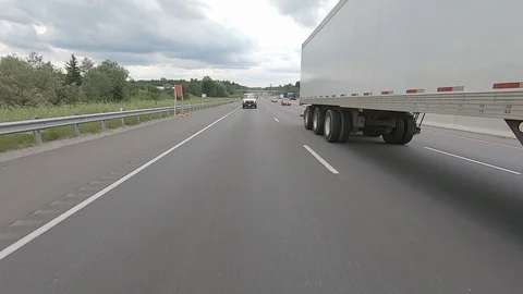 Driving plate reverse POV highway driving with cars and trucks Stock Footage 112908623