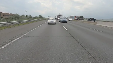 Driving plate reverse POV highway driving with cars and trucks traffic Stock Footage 112911340