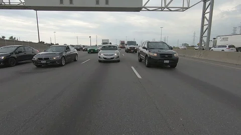 Driving plate reverse POV highway driving with cars and trucks traffic Stock Footage 112912608