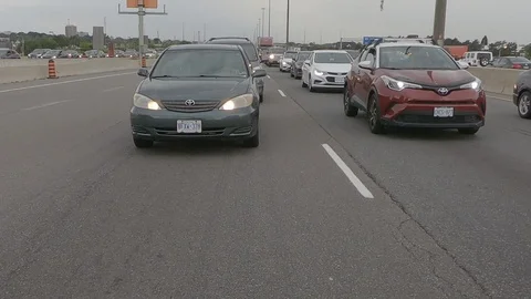 Driving plate reverse POV highway driving with cars and trucks traffic Stock Footage 112913557