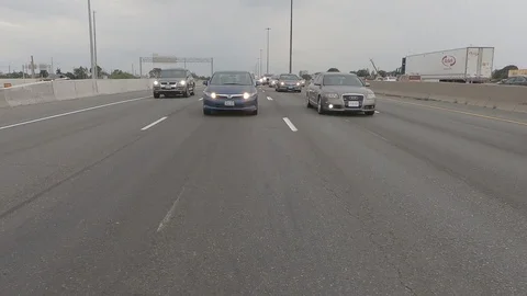Driving plate reverse POV highway driving with cars and trucks traffic Stock Footage 112914113