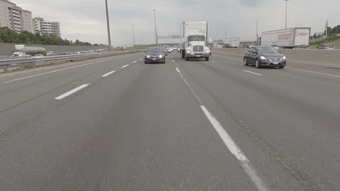 Driving plate reverse POV highway driving with cars and trucks traffic Stock Footage 112914599