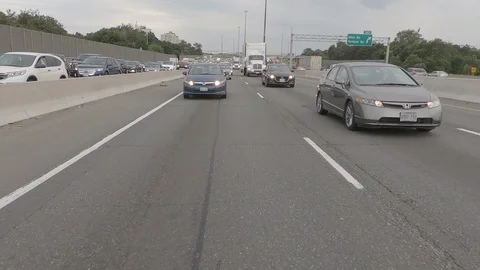 Driving plate reverse POV highway driving with cars and trucks traffic Stock Footage 112914647