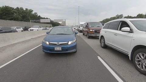 Driving plate reverse POV highway driving with cars and trucks traffic Stock Footage 112915599
