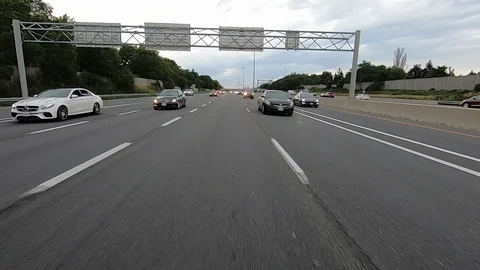 Driving plate reverse POV highway driving with cars and trucks traffic Stock Footage 112919563