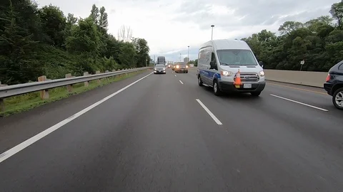 Driving plate reverse POV highway driving with cars and trucks traffic Stock Footage 112920546