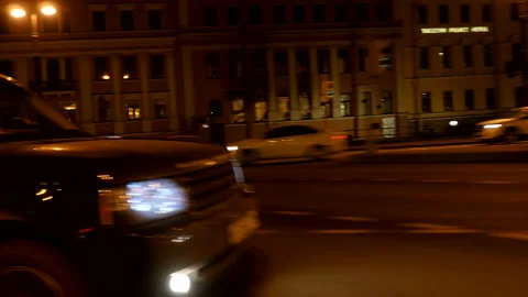 Driving plate side Left, car moves at the night street with car traffic Stock Footage 99653681