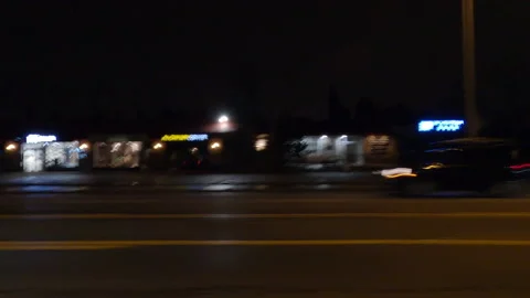 Driving plate with side view on dark city streets at night with buildings Vídeos de archivo 149798670