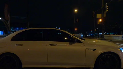Driving plate with side view on dark city streets at night with buildings 動画素材 149810867