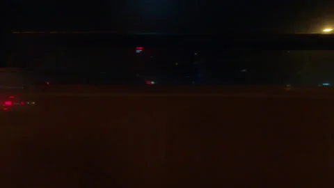 Driving plate with side view on dark city streets at night with buildings 動画素材 149811945