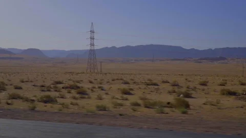 Driving Plate Side View of the desert with High Tension Tower Stock Footage 103522927