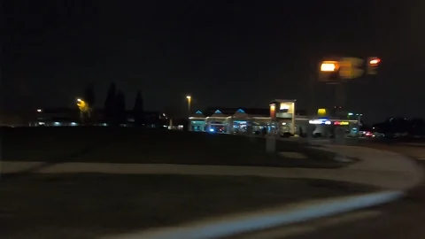 Driving plate side view driving on dark city streets at night Stock Footage 99129607