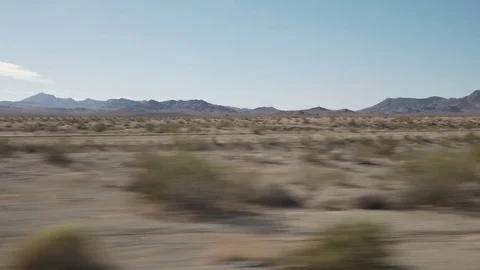 Driving plate side view moving through desert in car Stock Footage 83250953