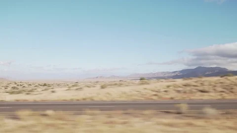 Driving plate side view moving through desert in car Stock Footage 83843311