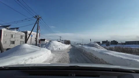 Driving poor snowy road barely passable after snowstorm Sapporo Stock Footage 333229676