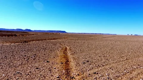 Driving pov on a bumpy dirt road through the vast, arid moroccan desert lan.. Stock Footage 332217347
