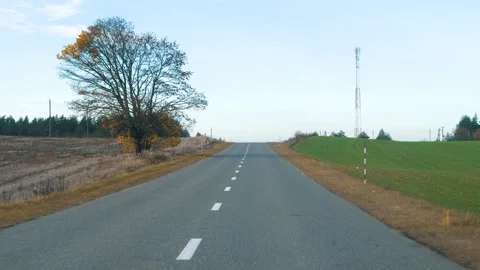 Driving pov on empty country road through autumnal hilly landscape Video stock 320534809