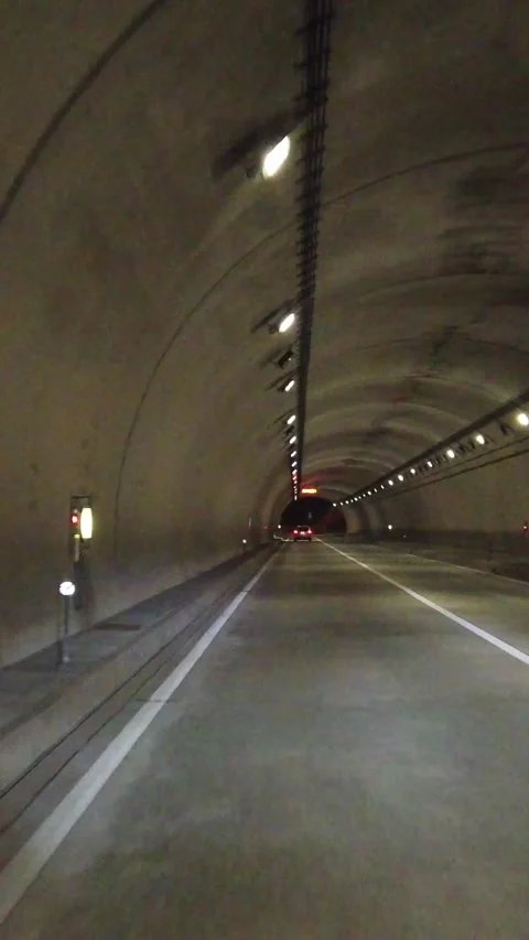 Driving POV inside Highway dark tunnel illuminated, vertical view, driver's seat Stock Footage 325834000