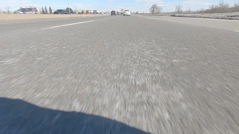 Driving POV low angle fast to the pavement on highway with traffic Stock Footage 103079534