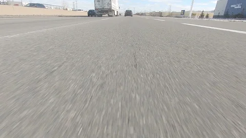 Driving POV low angle fast to the pavement on highway with traffic Stock Footage 103080235
