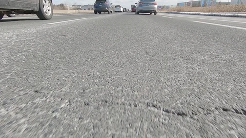 Driving POV low angle fast to the pavement on highway with traffic Stock Footage 103083278