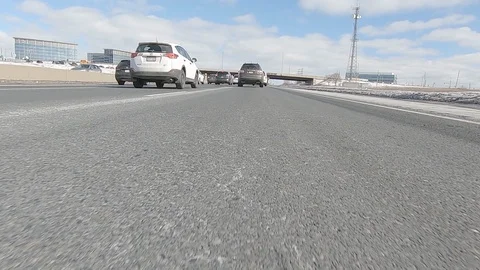 Driving POV low angle fast to the pavement on highway with traffic Stock Footage 103085104