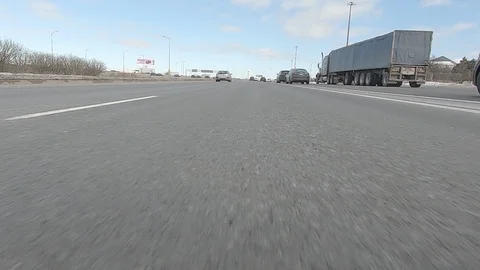 Driving POV low angle fast to the pavement on highway with traffic Video stock 103087538