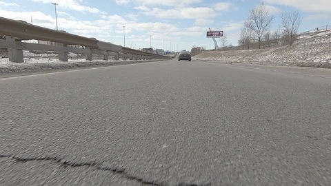 Driving POV low angle fast to the pavement on highway with traffic Stock Footage 103087832