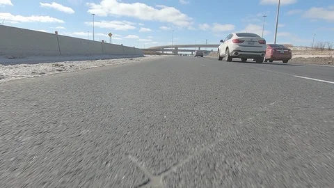 Driving POV low angle fast to the pavement on highway with traffic Stock Footage 103088951