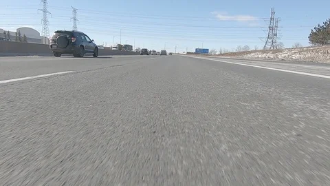 Driving POV low angle fast to the pavement on highway with traffic Stock Footage 103090812