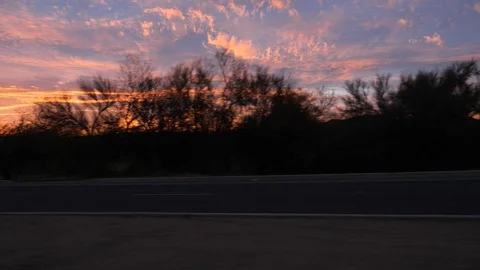 Driving POV passing under electric wires at sunrise Stock Footage 126923039