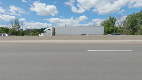 Driving  POV side view on highway at high speed with cars and truck traffic Stock Footage 158318985