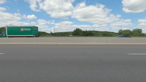Driving  POV side view on highway at high speed with cars and truck traffic Stock Footage 158320494